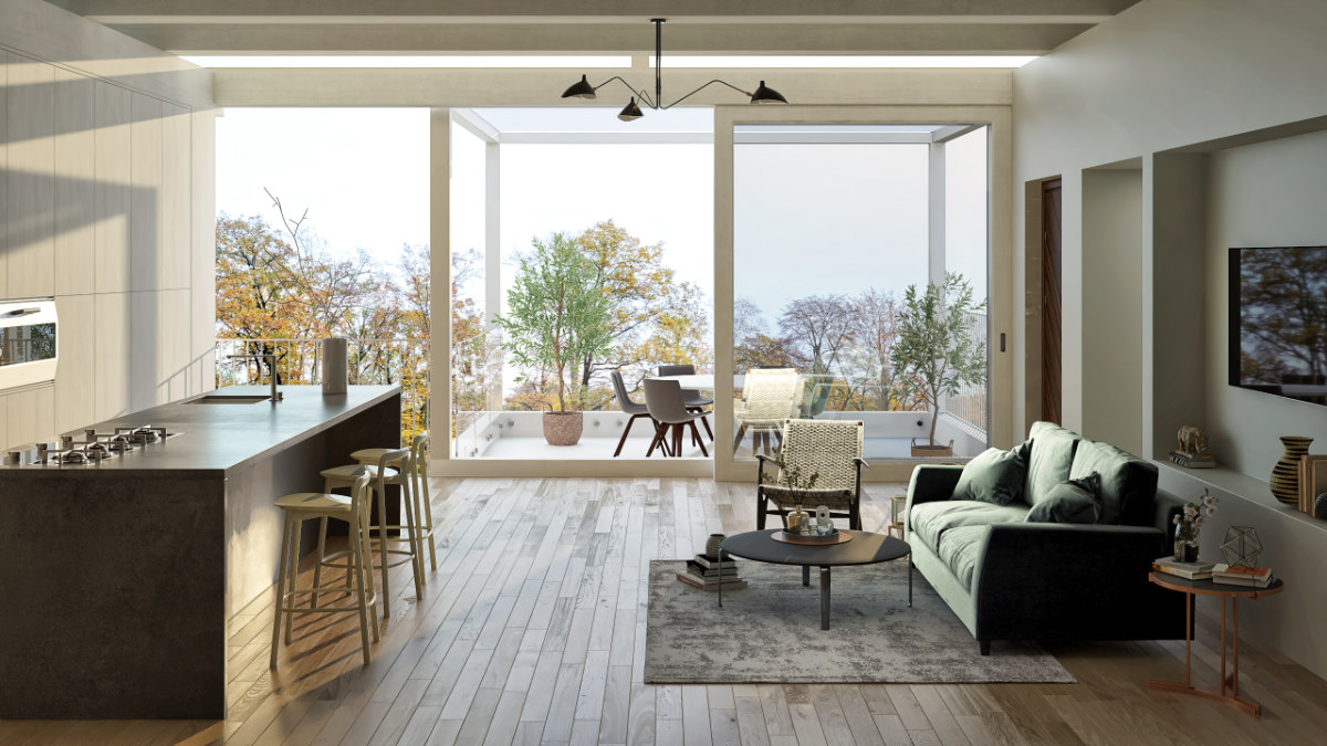 Blick in ein großes Zimmer, in dem sich eine moderne Küchenzeile mit Küchenblock und Sofaecke befindet. Symbolbild für kreative Raumaufteilung für große und kleine Räume